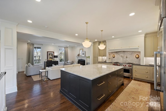 kitchen featuring pendant lighting, dark wood-type flooring, a center island, light stone counters, and high end stainless steel range