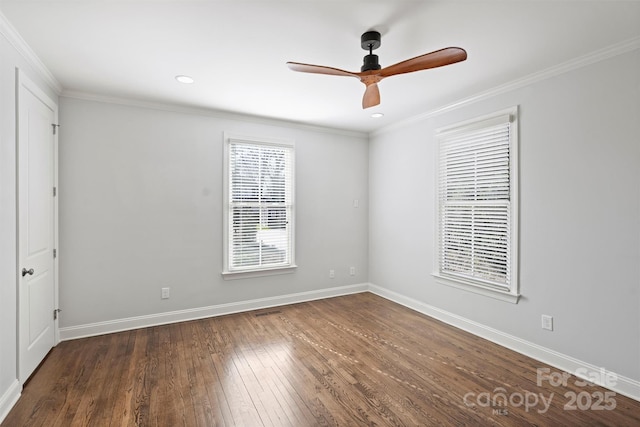 empty room featuring crown molding, dark hardwood / wood-style floors, and ceiling fan