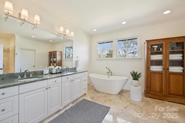 bathroom with ornamental molding, vanity, and shower with separate bathtub