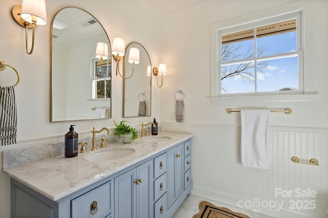 bathroom with vanity and crown molding