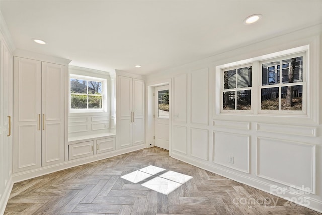 spare room with crown molding and light parquet floors