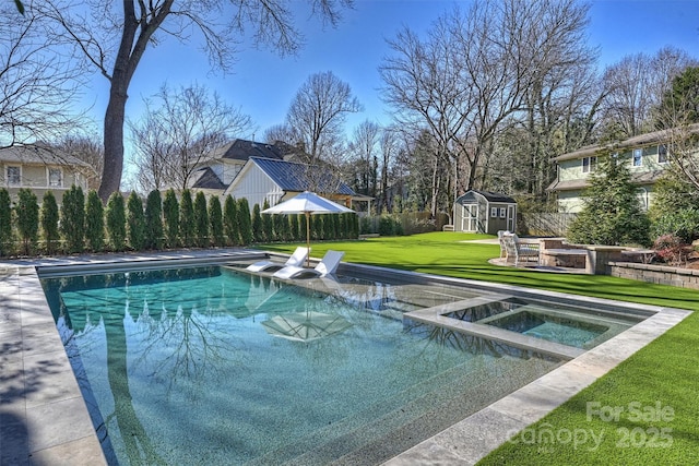 view of pool featuring an in ground hot tub, a yard, and a shed