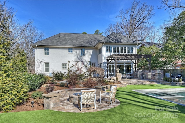 back of property with a patio, a fire pit, a yard, and a pergola