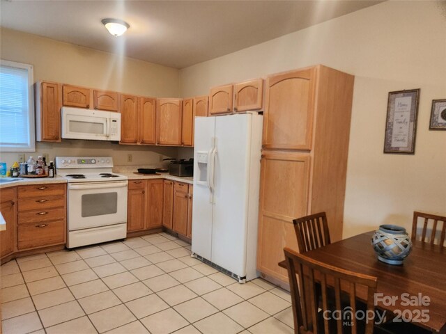 979 W Chapel Rd, Asheville, NC 28803 - kitchen with white appliances, light countertops, and light brown cabinets