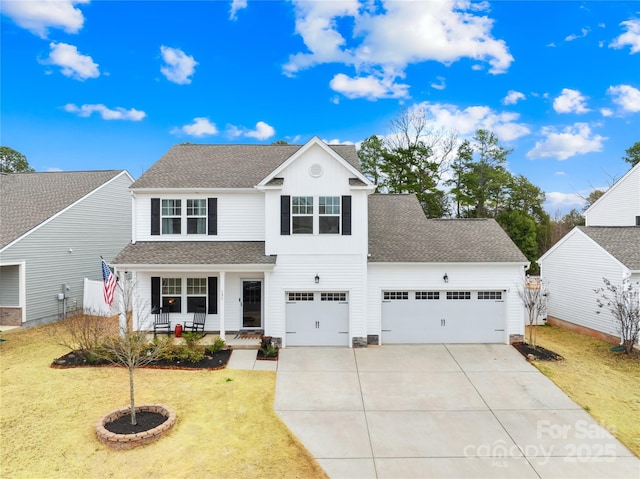 view of front of property with a garage, a front lawn, and covered porch