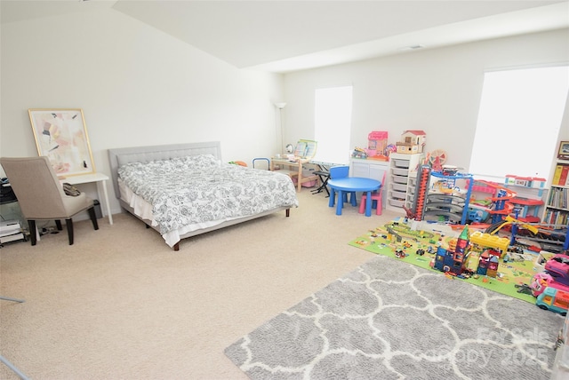 carpeted bedroom with lofted ceiling