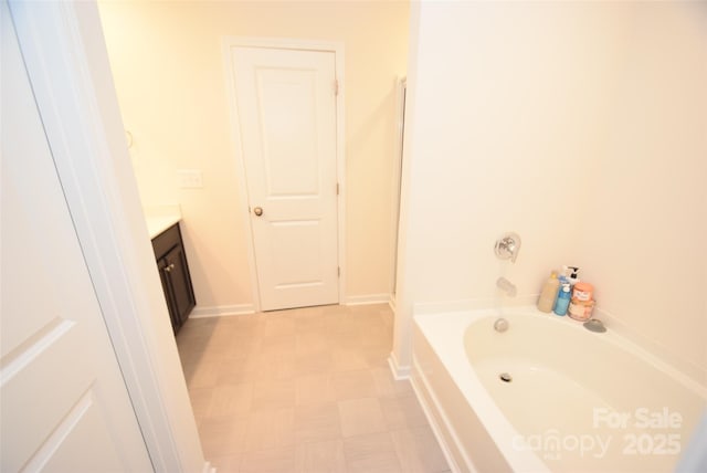 bathroom featuring vanity and a tub to relax in