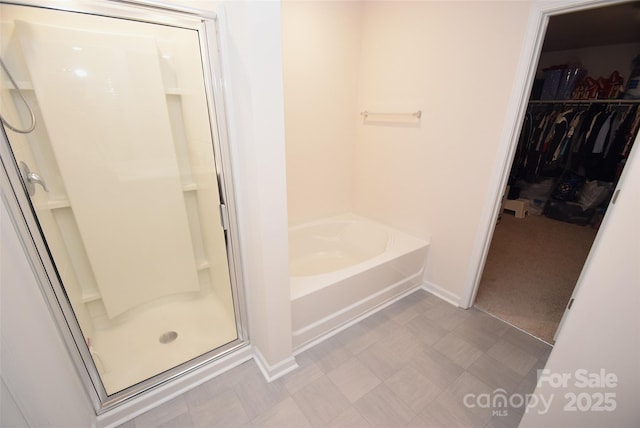 bathroom featuring shower with separate bathtub