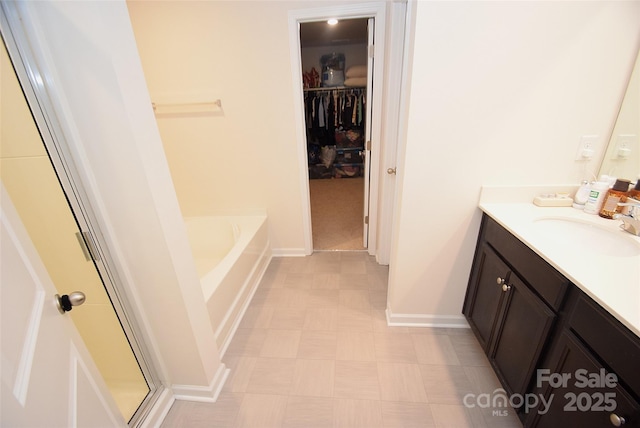 bathroom with vanity and independent shower and bath