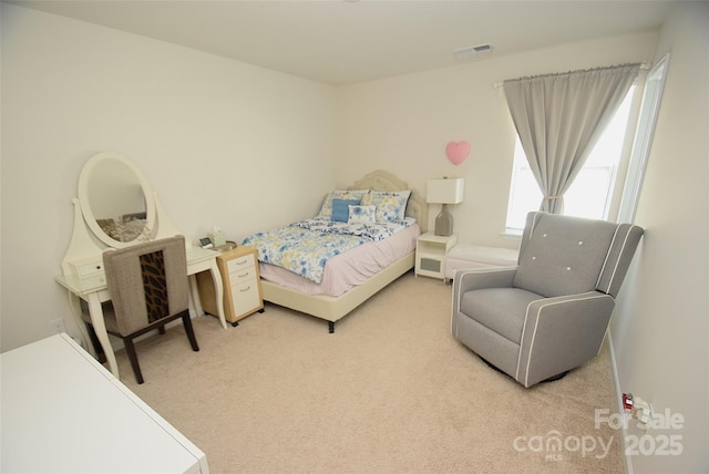 bedroom with light colored carpet