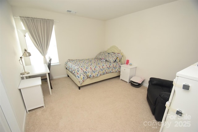 carpeted bedroom featuring washer / dryer