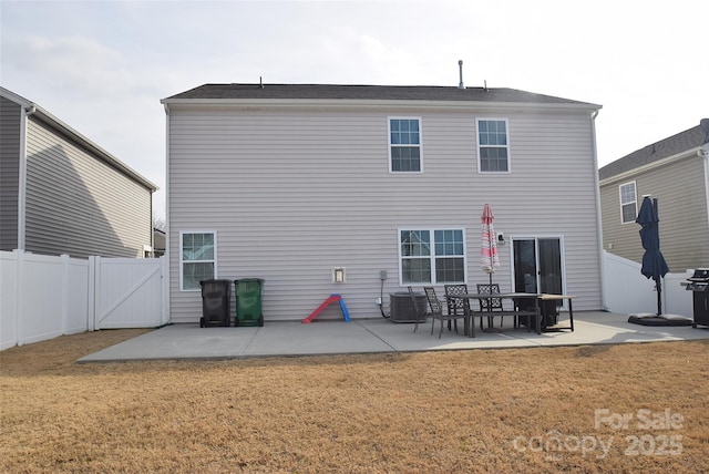 back of house with a yard, a patio area, and central AC