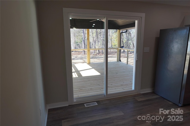 doorway to outside with dark wood-type flooring