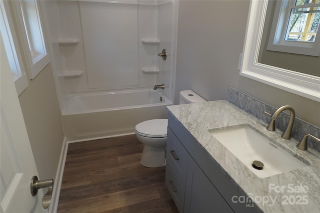 full bathroom with wood-type flooring, toilet, vanity, and  shower combination