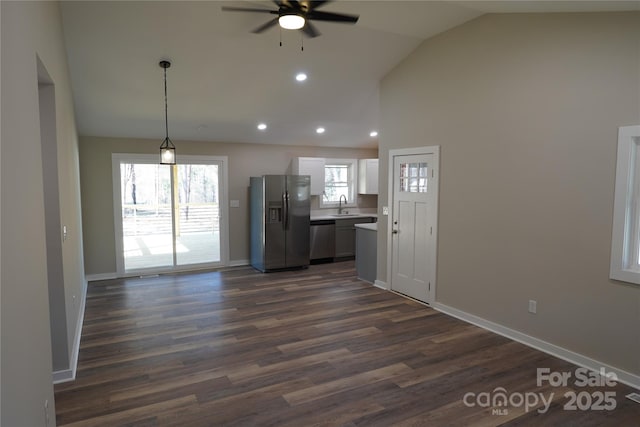 kitchen featuring sink, hanging light fixtures, stainless steel appliances, white cabinets, and dark hardwood / wood-style flooring