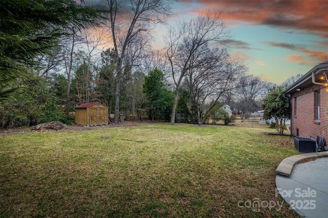 yard at dusk with a storage unit