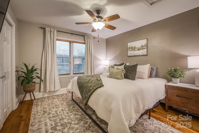 bedroom featuring ceiling fan, hardwood / wood-style floors, and a closet