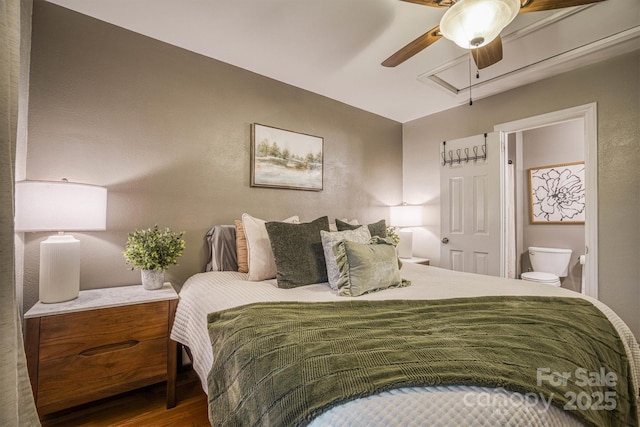 bedroom with hardwood / wood-style flooring, ensuite bath, and ceiling fan