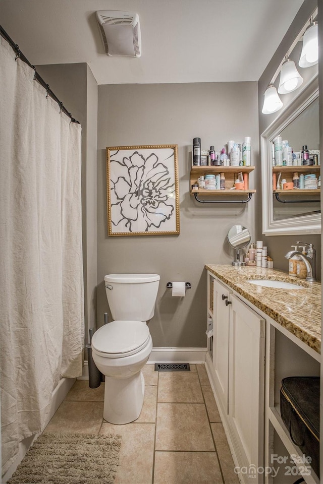 bathroom with vanity, tile patterned floors, and toilet