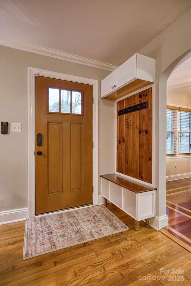 mudroom with crown molding and hardwood / wood-style floors