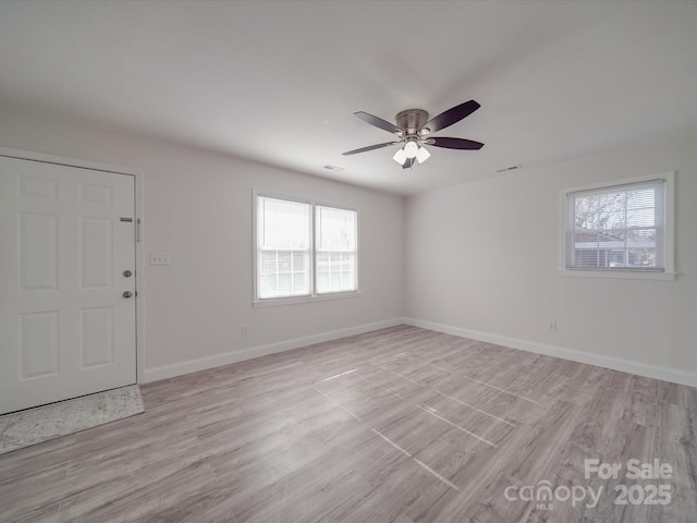 spare room with ceiling fan and light wood-type flooring