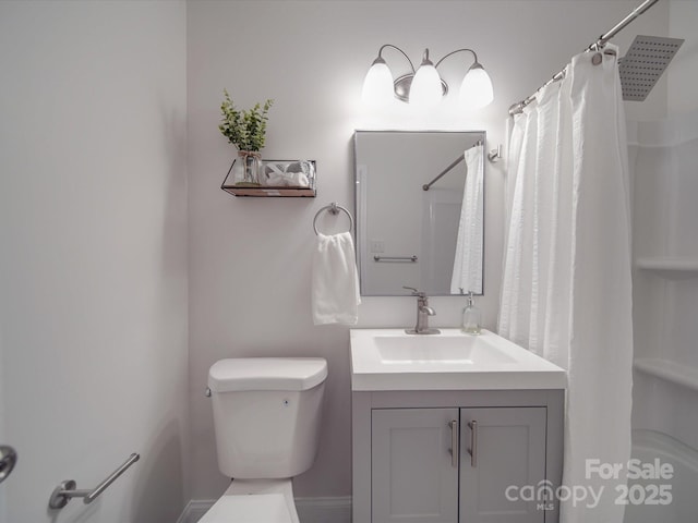 bathroom featuring vanity, toilet, and walk in shower