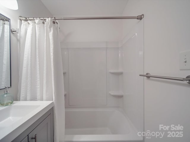 bathroom featuring vanity and shower / bathtub combination with curtain