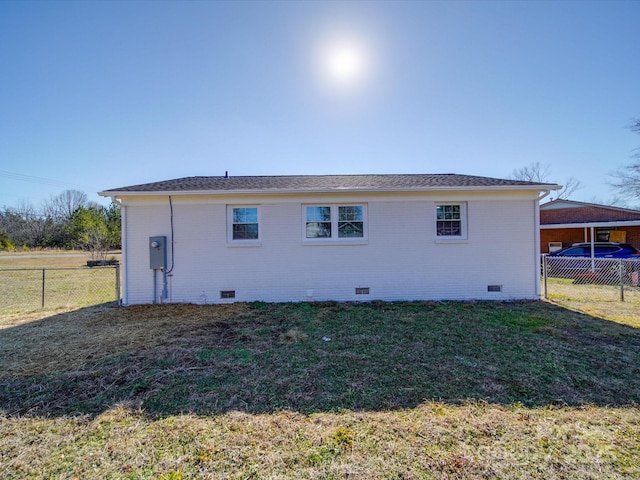 rear view of house with a yard