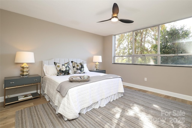 bedroom with ceiling fan and hardwood / wood-style floors