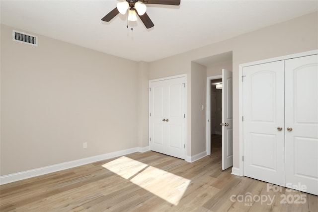 unfurnished bedroom with light hardwood / wood-style flooring, a closet, and ceiling fan