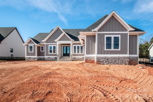 craftsman-style house with board and batten siding and a shingled roof