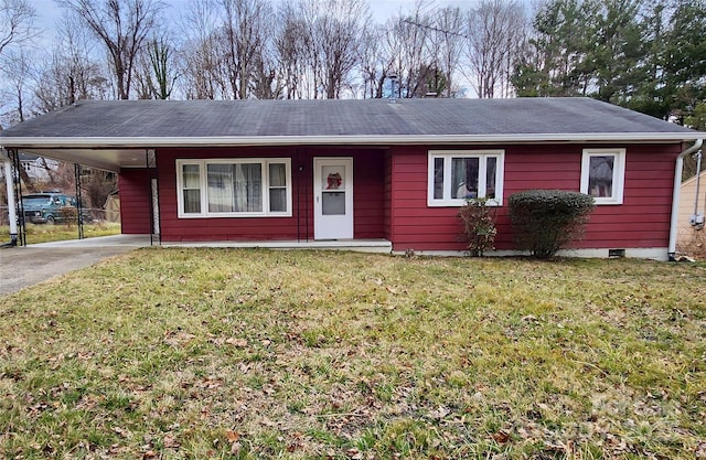 ranch-style house with an attached carport, driveway, and a front yard