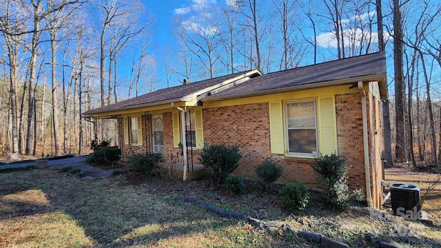 ranch-style home with central air condition unit