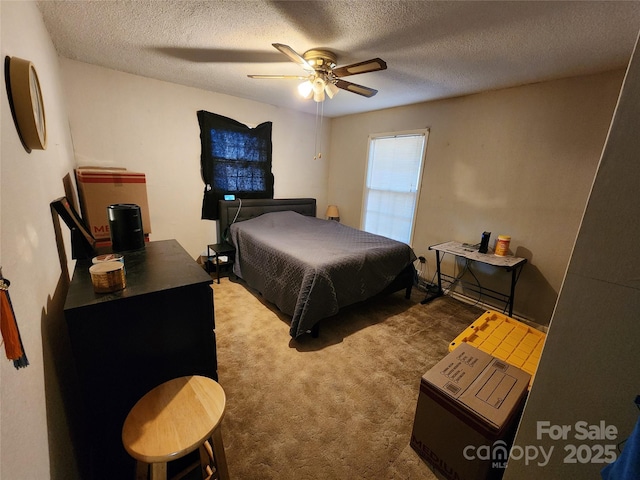 bedroom featuring ceiling fan, carpet, and a textured ceiling