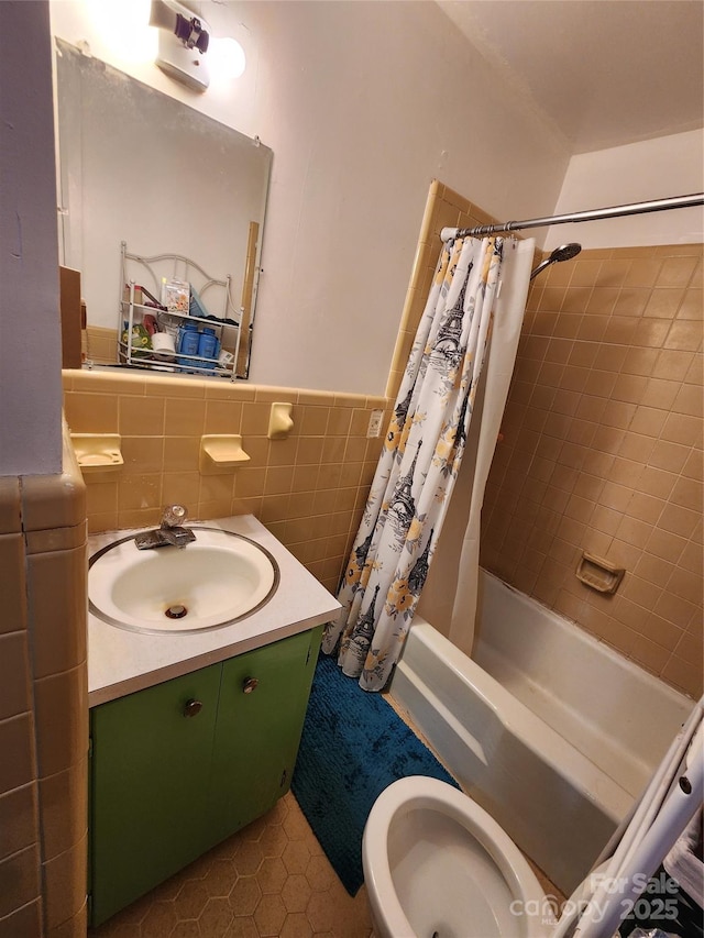 full bathroom with tile walls, vanity, shower / bath combination with curtain, and toilet