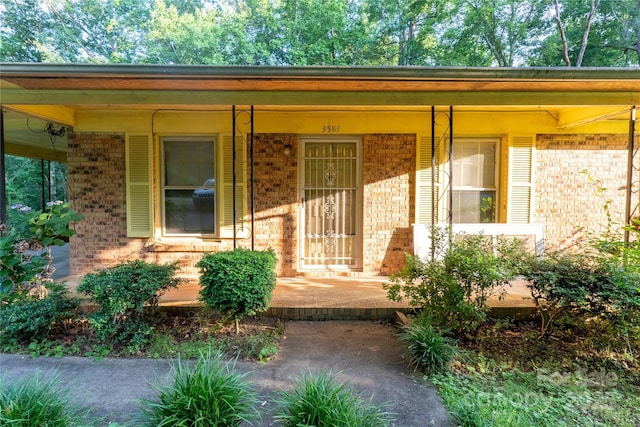 3581 Thompson St, Newton, NC 28658 - doorway to property featuring brick siding and covered porch