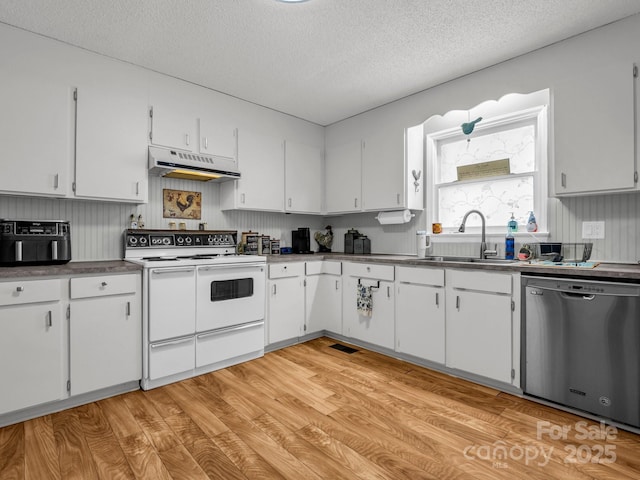 kitchen featuring sink, dishwasher, double oven range, light hardwood / wood-style floors, and white cabinets