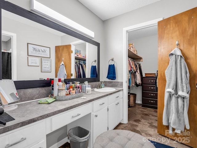 bathroom with vanity and a textured ceiling