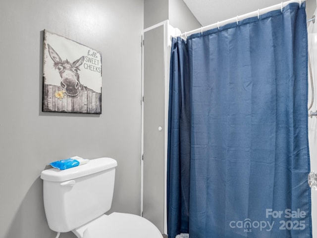 bathroom with toilet and walk in shower