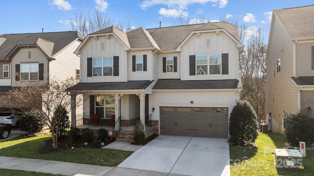 view of front of house with a garage, a front yard, central air condition unit, and covered porch