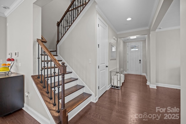 foyer featuring ornamental molding and dark hardwood / wood-style floors