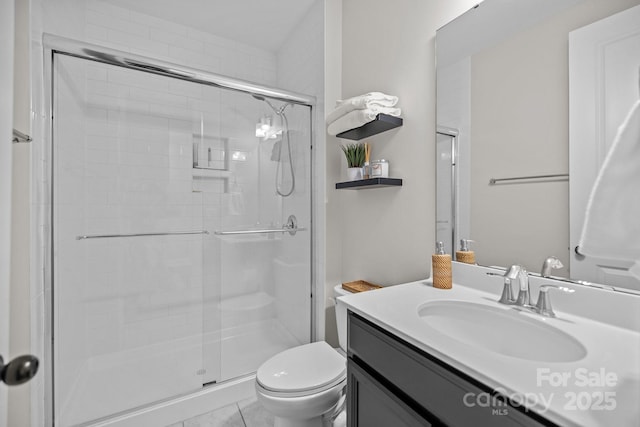 bathroom with vanity, toilet, and a shower with shower door