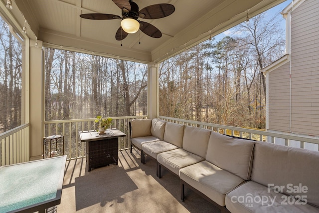 sunroom featuring a wealth of natural light and ceiling fan