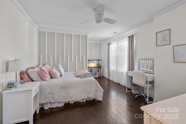 bedroom featuring crown molding, dark wood-type flooring, and ceiling fan