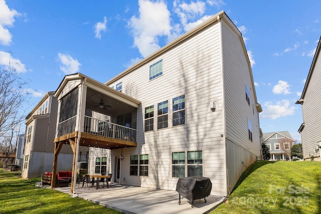 back of house featuring ceiling fan, a yard, a sunroom, and a patio