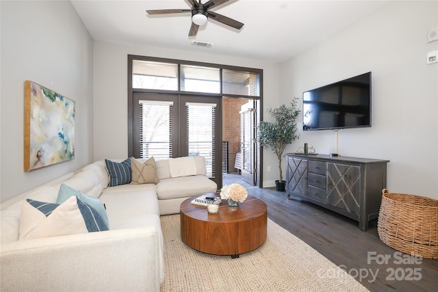 living room featuring hardwood / wood-style floors and ceiling fan