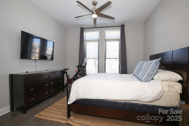 bedroom with dark hardwood / wood-style floors and ceiling fan