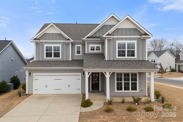 view of front facade featuring a garage, driveway, a shingled roof, and board and batten siding