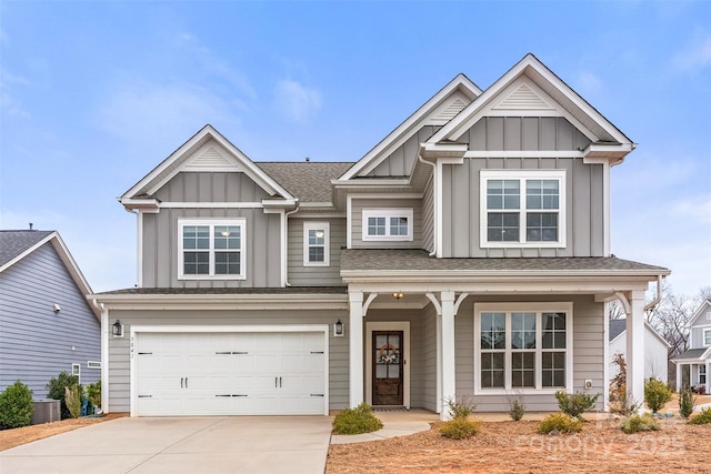 craftsman house with driveway, an attached garage, central AC unit, and board and batten siding