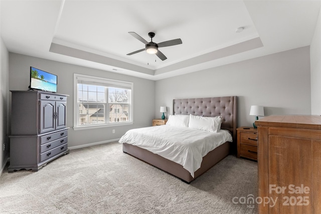 bedroom featuring baseboards, a ceiling fan, a raised ceiling, and carpet flooring